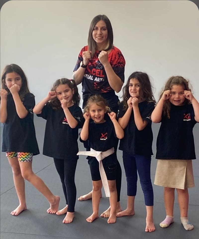 Kids MMA class group photo with fighting stances in Boca Raton