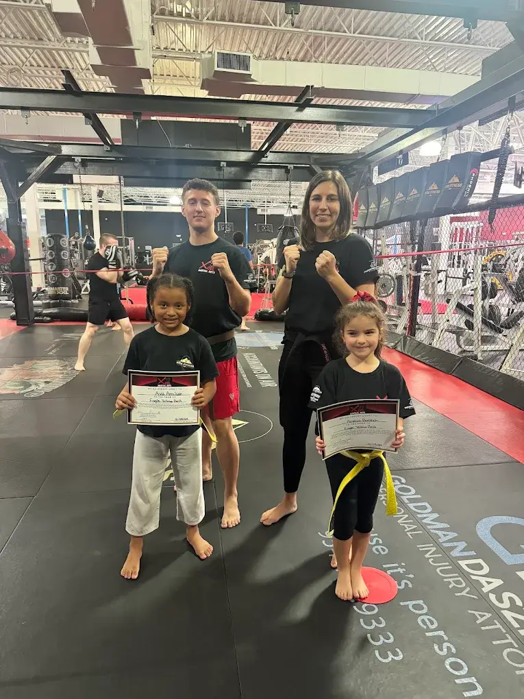 Kids belt ceremony with instructors at Xcel Martial Arts in Boca Raton