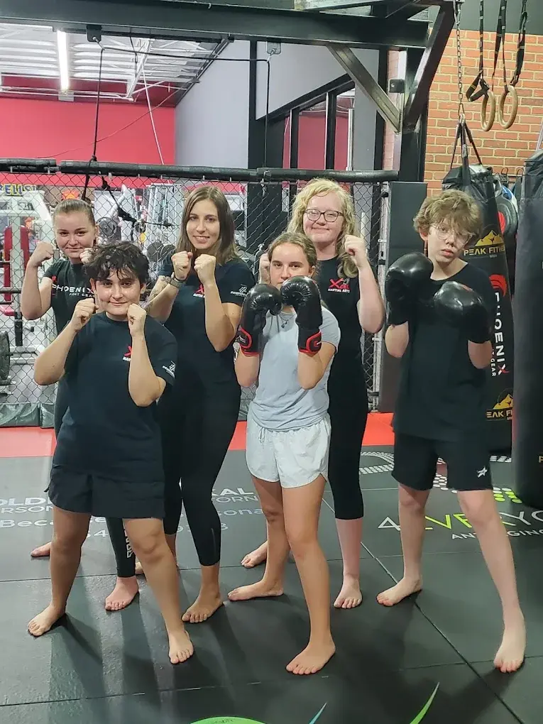 Kids kickboxing group with instructor Maria at Xcel Martial Arts Boca Raton